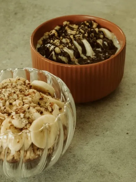 Two dessert cups with banana and chocolate